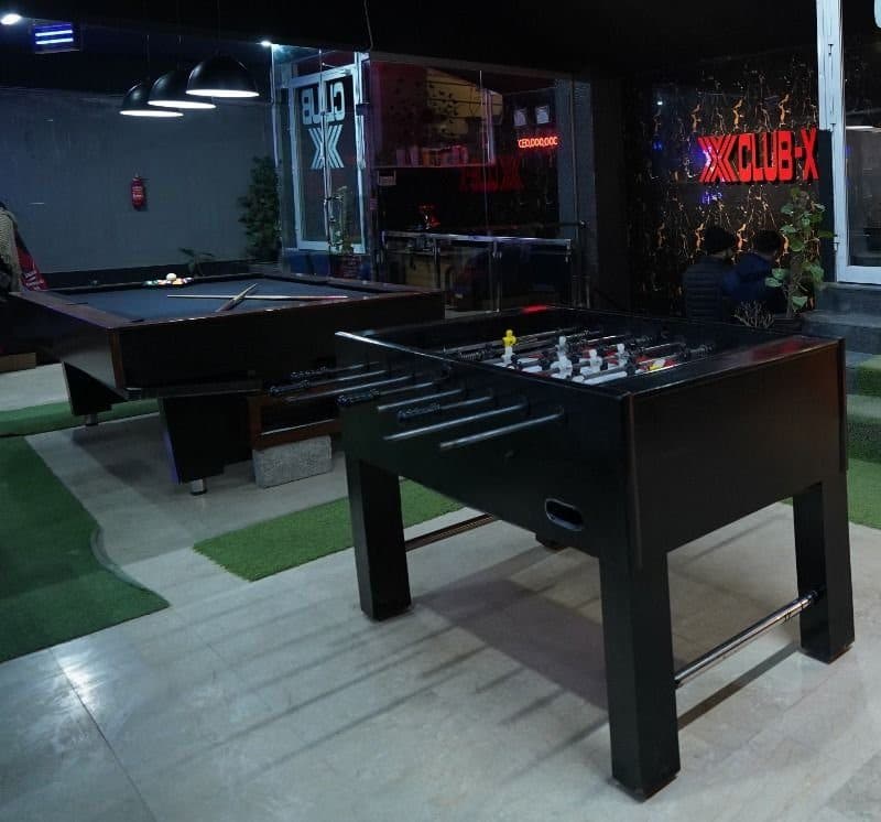 Pool table and foosball table in the Club X lounge